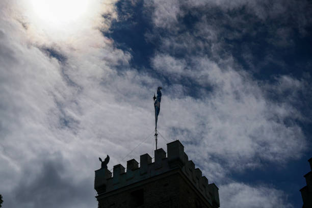 Silhouette of a tall Gothic church spire against a blue sky with clouds in Stockholm.Close up photo