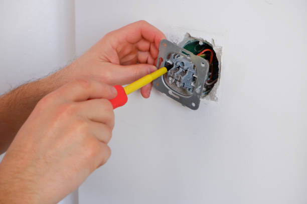 istock The electrician unscrews the switch with a screwdriver. Close-up on the hands. The routine work of an electrician. Checking contacts. Switch replacement. 1456793612