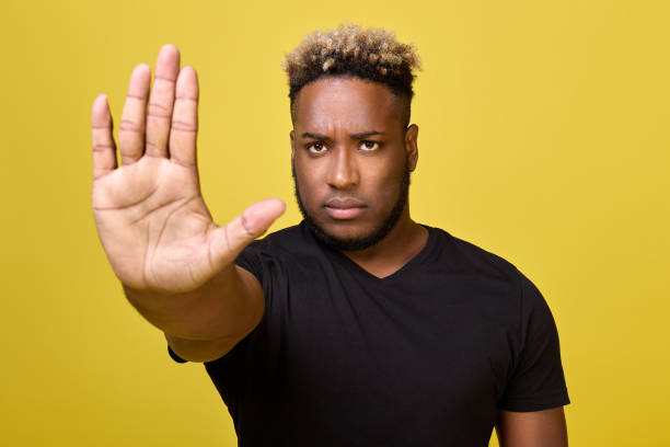 istock Stop there is no road - guy shows with stopping hand gesture with serious look 1456793645