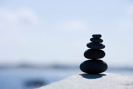 Stone pyramid in balance with out of focus background