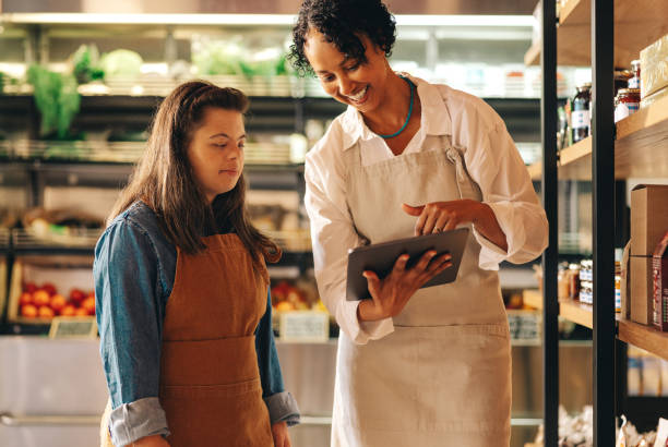 istock Happy grocery store supervisor using a digital tablet with her employee 1456794846