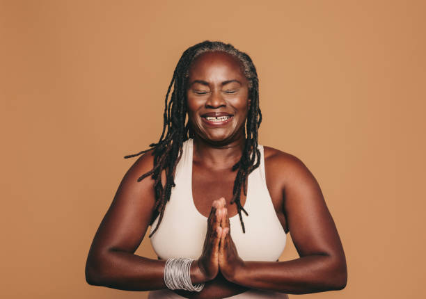 istock Happy black woman meditating in a studio 1456794927