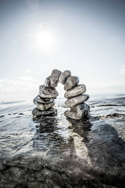 istock Stone arch in water with horizon above water 1456794979