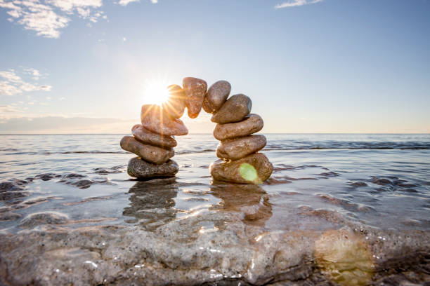 istock Stone arch in the water with horizon over water 1456795017