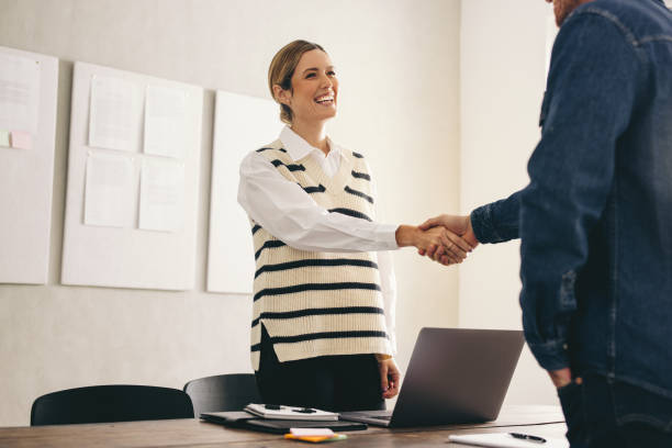 istock New business partners shaking hands in an office 1456795225