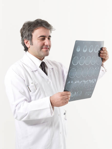 istock Doctor looks at brain scan images 1456795553
