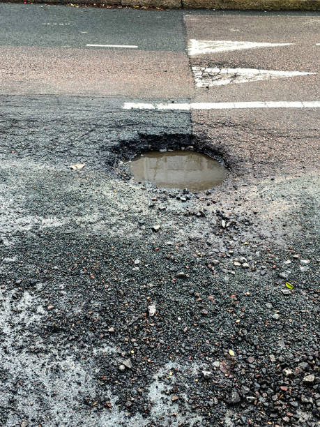 istock Road surface in need of repair 1456795652