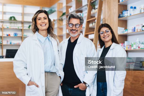 Group Of Pharmacists Standing Together In A Chemist Stock Photo - Download Image Now
