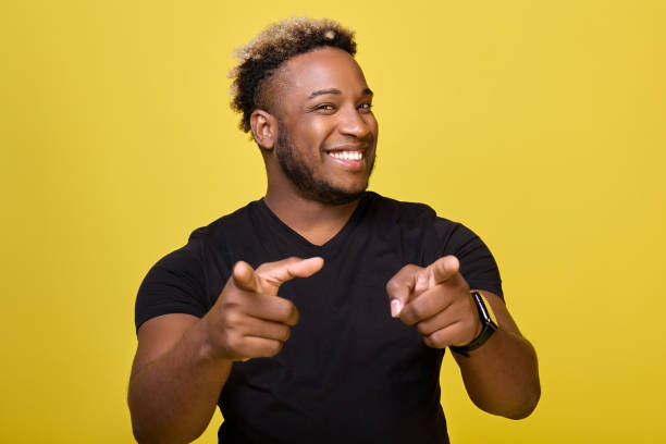 istock Happy young man with a smart watch points his index finger at the camera 1456797281