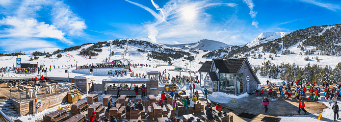 El Tarter, Andorra, Jan 2020 Wide, panoramic view on bars and restaurants, ski slopes and mountains. People relaxing and enjoying winter ski holidays