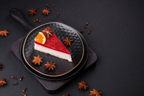 istock Delicious sweet cheesecake with raspberry jam on a black ceramic plate 1456800264