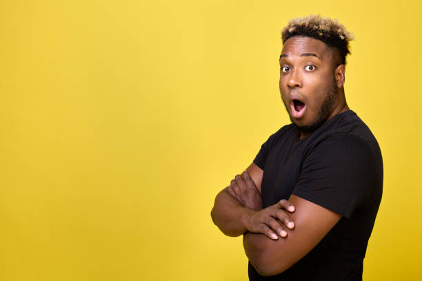 istock Handsome young man stands sideways with worried and surprised expression 1456801342