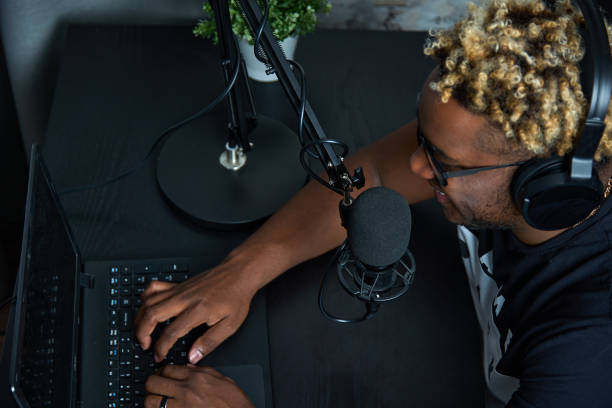 istock Black man communicates with podcast listeners in an online chat 1456804053
