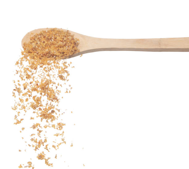 istock Fried Garlic pour fall down from wooden spoon, golden yellow fried garlic float abstract fly. Beautiful fried garlic splash stop in air, food object design. White background isolated high speed freeze 1456805013