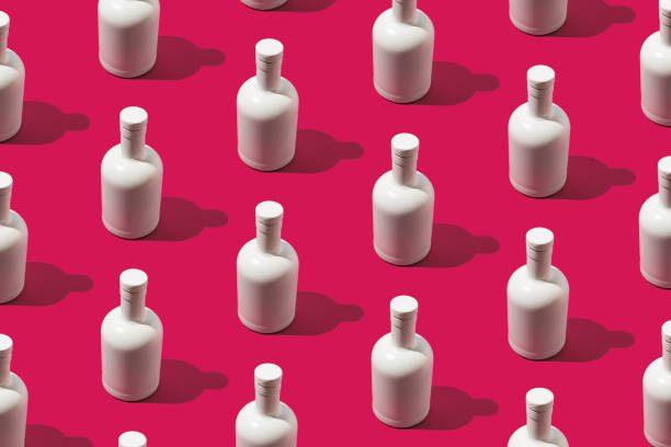 istock Trendy beverage pattern made with white bottle on magenta background. Minimal vibrant concept. 1456807695