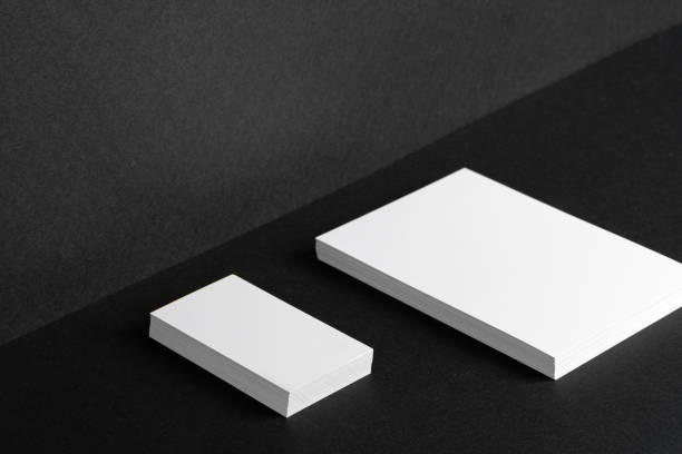 istock Stacked white businesscards for branding identity on black background 1456808117