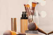 Decorative cosmetics and tools on dressing table in makeup room