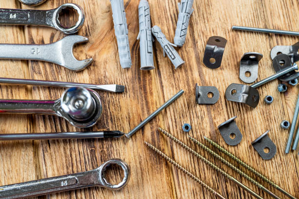 istock Furniture assembly tools set with screw dowel wrench and bolt on wooden table texture. 1456809183