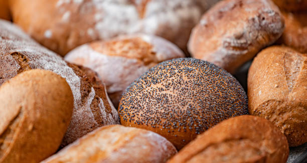 istock Freshly baked natural bread is on the kitchen table. 1456809616