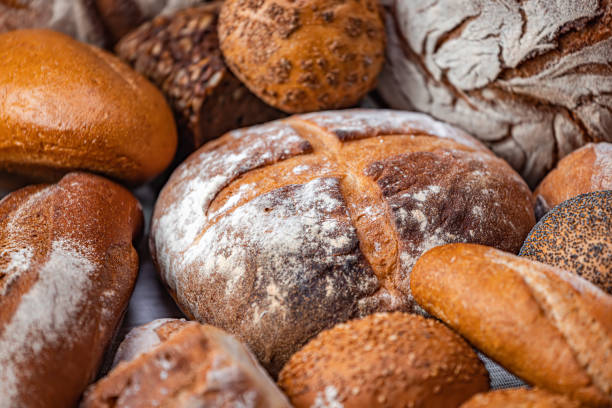 istock Freshly baked natural bread is on the kitchen table. 1456809624