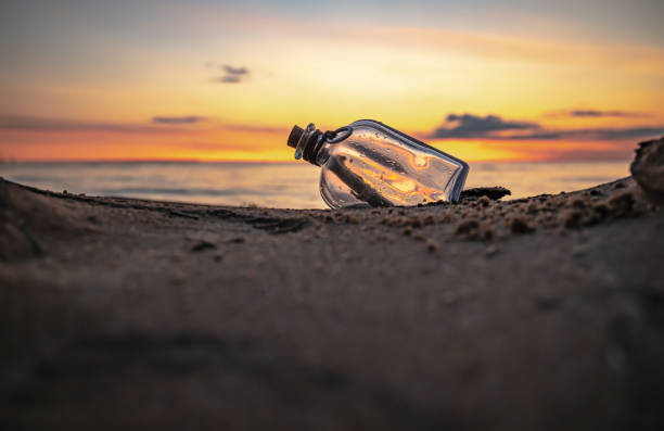 istock Message in the bottle against the Sun setting down 1456809889