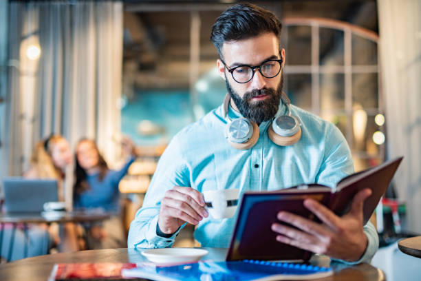 istock Men reading a book in university cafe 1456810227