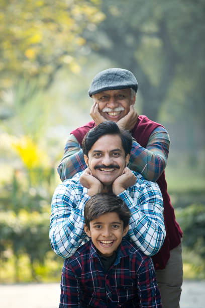 istock Joyful Indian family standing back to back at park 1456811536