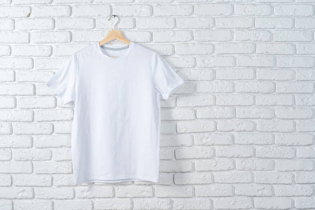 istock White t-shirt hanging on hanger against brick wall 1456811908