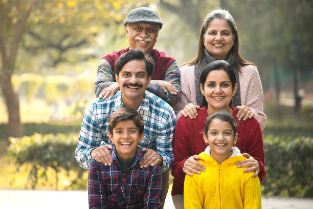 istock Cheerful multi generation family standing back to back at park 1456813270
