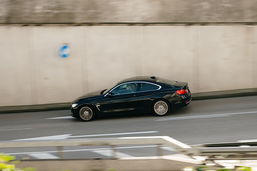 Santander, Spain - 12 January 2023: A BMW 4 Series coupé in motion on a road in Santander, Spain.