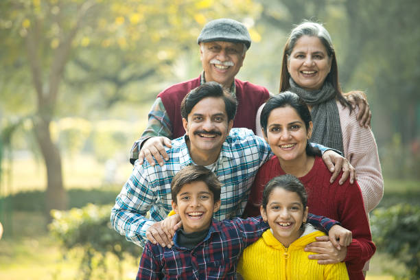 istock Cheerful multi generation family standing back to back at park 1456813780