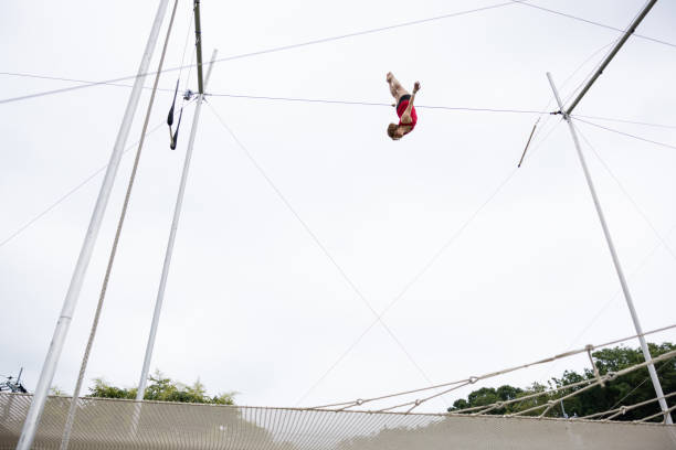 istock Mature trapeze artist flying in the sky 1456815656