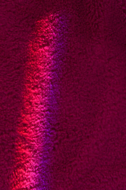 istock Bright ray of light fallen on wine red flaffy carpet close view 1456815775