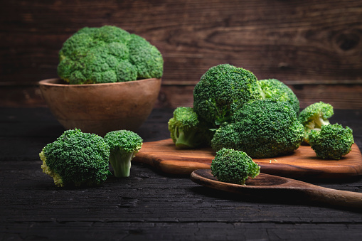 Fresh organic broccoli shot on rustic wooden table