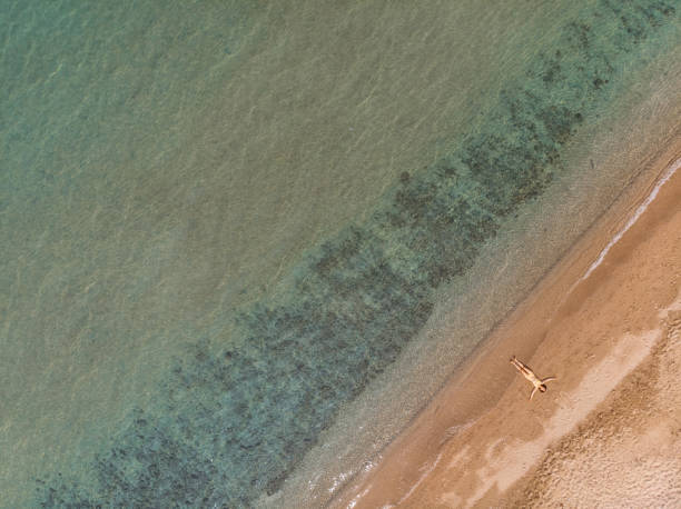 istock Young Woman Sunbathing On The Beach In Thasos 1456816701