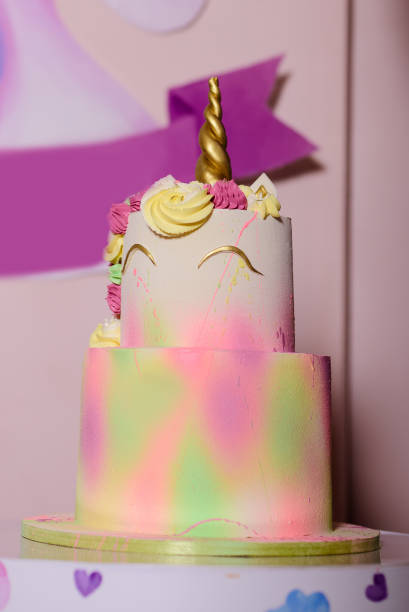 istock Delicious two-tiered birthday cake decorated in unicorn style. 1456820372