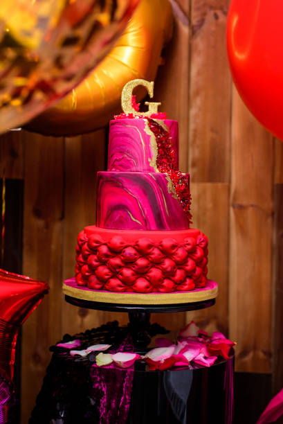 istock Red three-tiered birthday cake on a photo zone 1456820613
