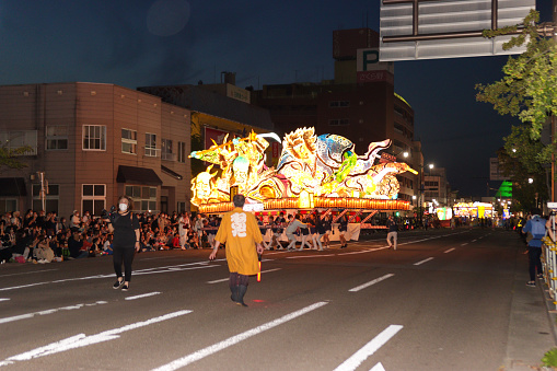 AOMORI, JAPAN - AUGUST 5: A lighted float is carried during a parade at the Aomori Nebuta Festival on August 5, 2022 in Aomori, Japan. Aomori Nebuta Festival is a summer festival held from August 2 to 7 in Aomori City, Aomori Prefecture. It is considered one of the three major festivals in Tohoku. It was the first time in three years that the festival was held due to the COVID-19 pandemic.