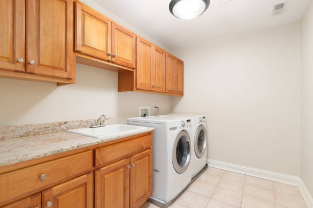 istock A laundry room with wood cabinets and white appliances. 1456821533