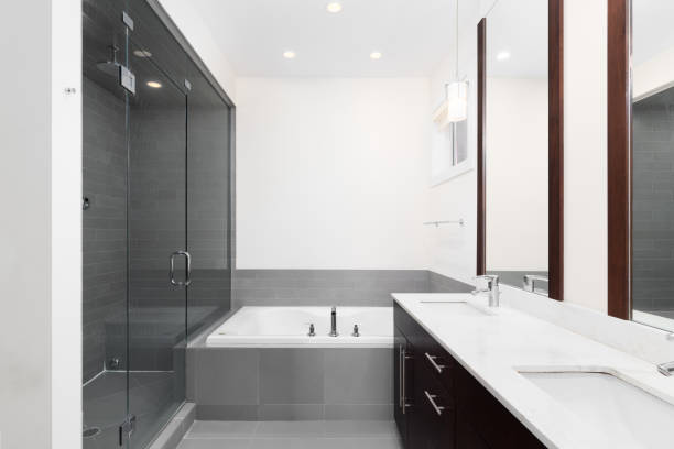 istock A bathroom with a white countertop, bathtub, and walk-in shower. 1456821598