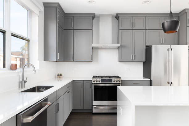 istock A grey kitchen with white countertops and stainless steel appliances. 1456822065