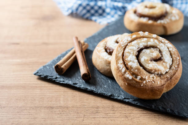 istock Cinnamon rolls buns on wooden table. Kanelbulle Swedish dessert 1456822691