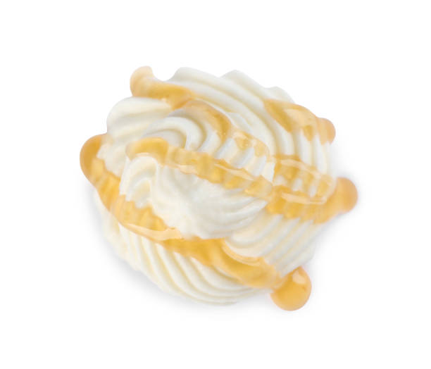 istock Delicious fresh whipped cream with caramel sauce isolated on white, top view 1456822699