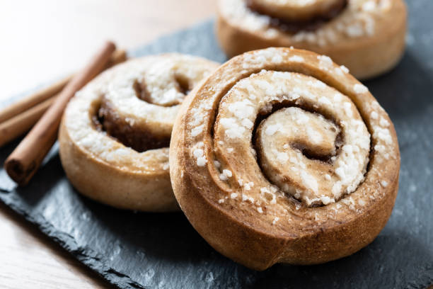 istock Cinnamon rolls buns on wooden table. Kanelbulle Swedish dessert 1456822730