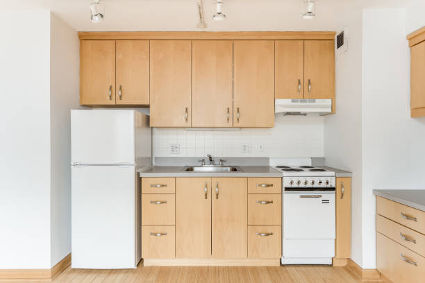 istock A small kitchen with wood cabinets and white appliances. 1456822798
