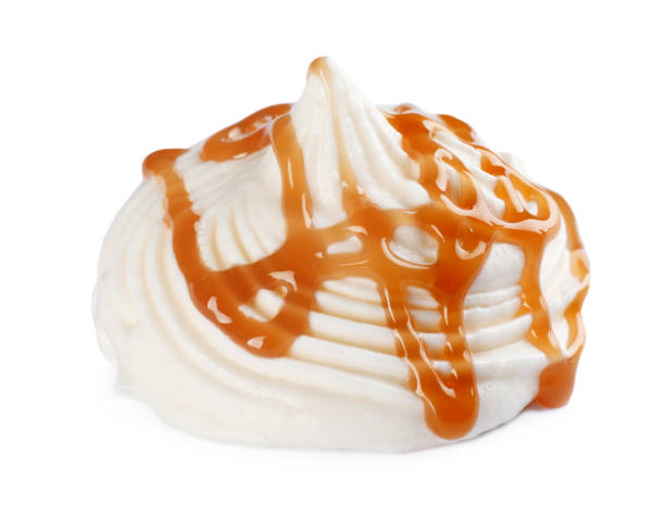 istock Whipped cream swirl with caramel sauce isolated on white background 1456822880