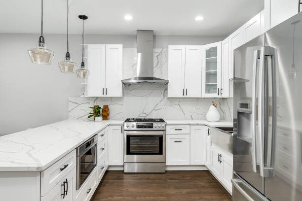istock A white kitchen with marble countertops and stainless steel appliances. 1456822911