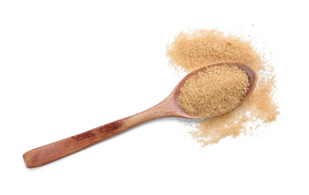 istock Wooden spoon and brown sugar on white background, top view 1456823207