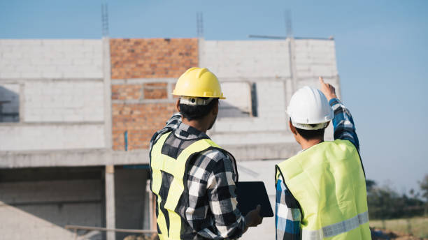 istock Structural engineer and architect working with blueprints discuss at the outdoors construction site. 1456823671