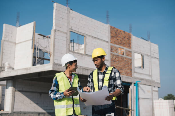 istock Structural engineer and architect working with blueprints discuss at the outdoors construction site. 1456823838